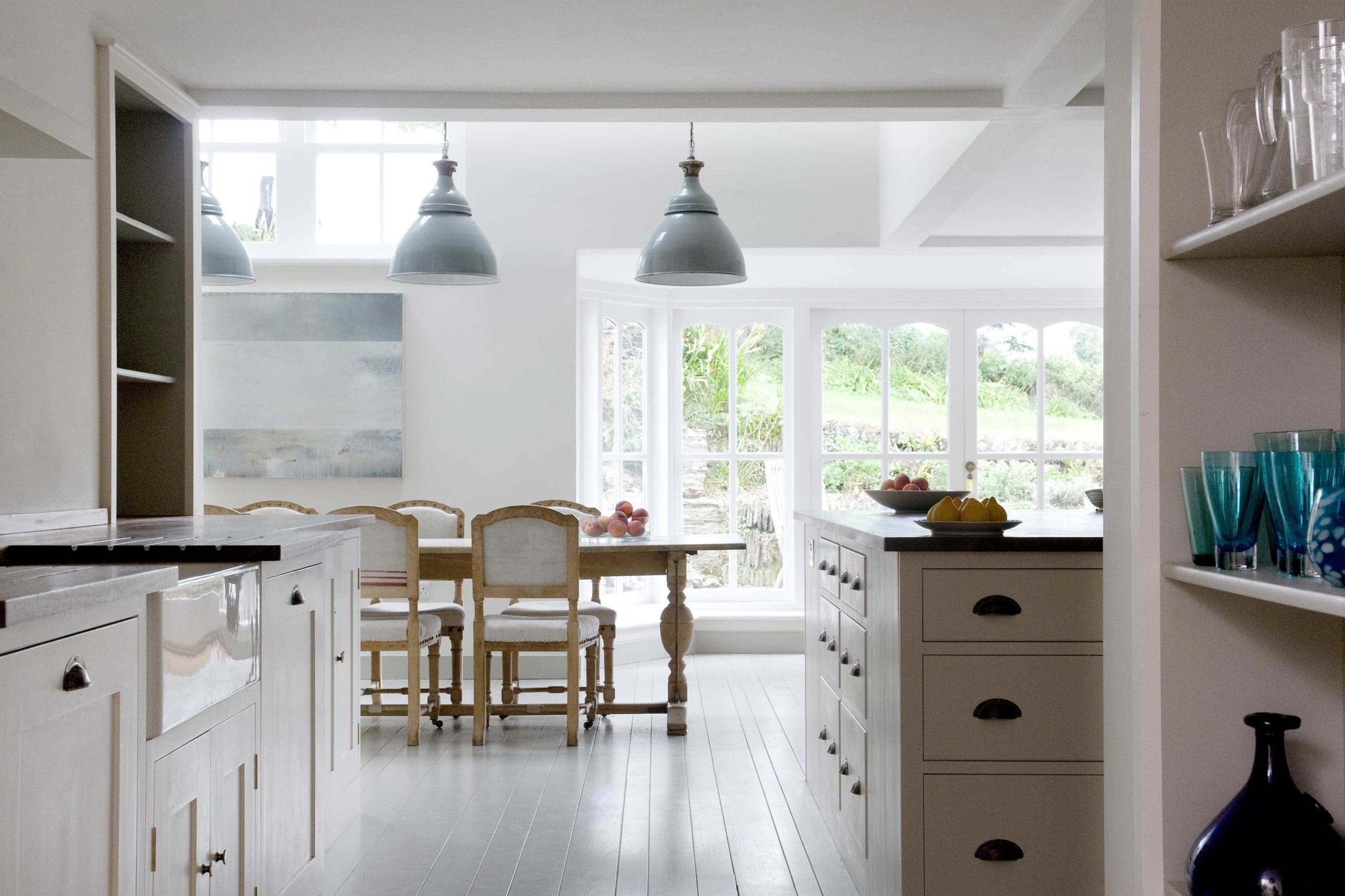  Cornish Holiday Home Kitchen with handcrafted Spitalfields Georgian Cabinetry with Wilkes doors and tourmaline cup handles and knobs. French Farmhouse Sink. Hand painted cupboards.