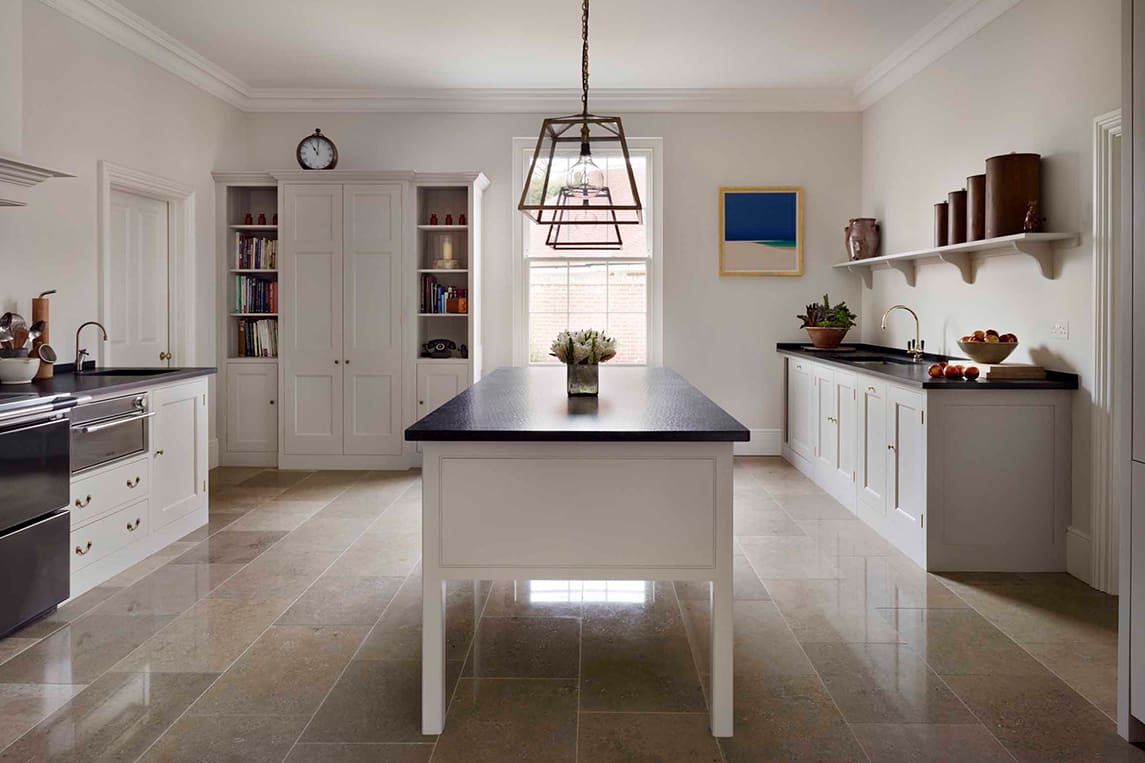  White wooden Lodge kitchen with black stone work surfaces